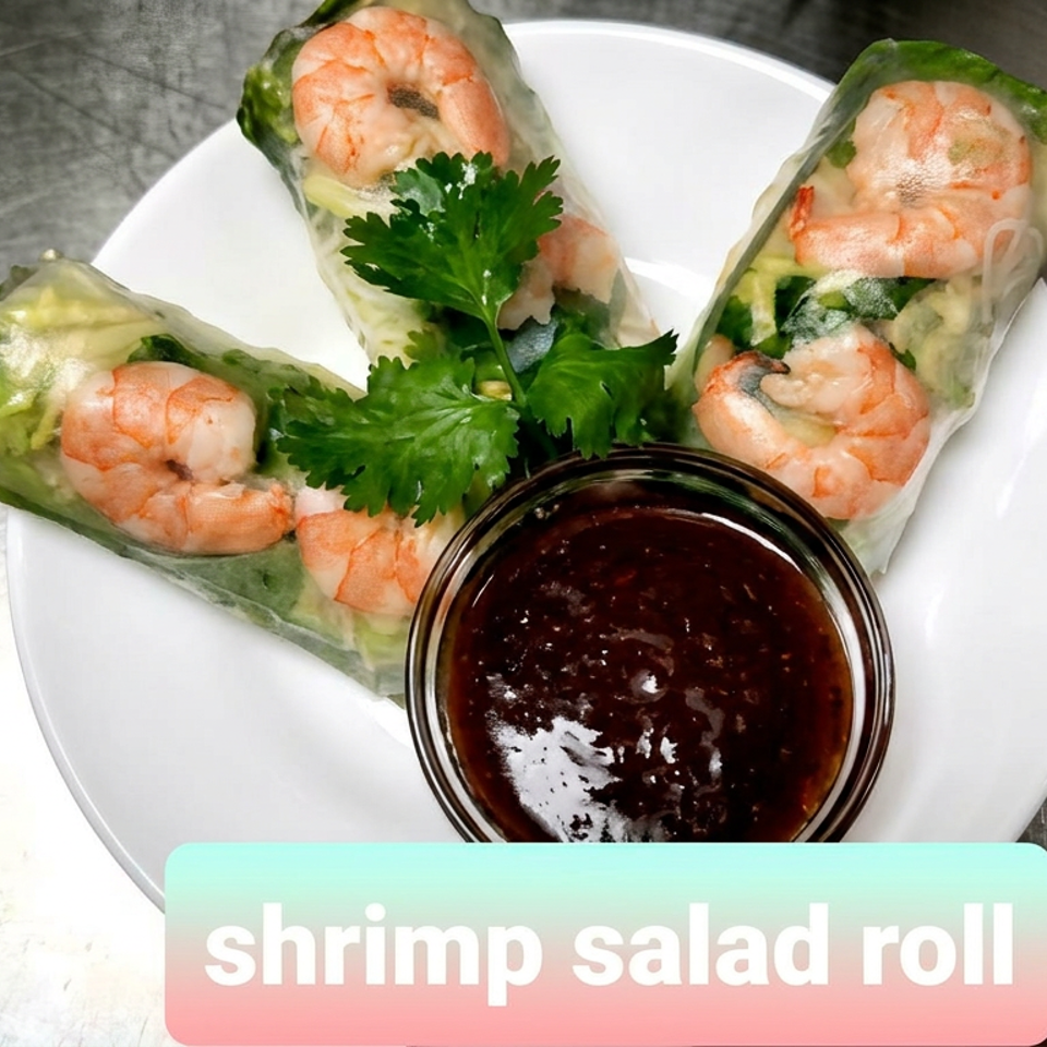 Three shrimp salad rolls with fresh herbs and vegetables surround a bowl of dark dipping sauce on a white plate.